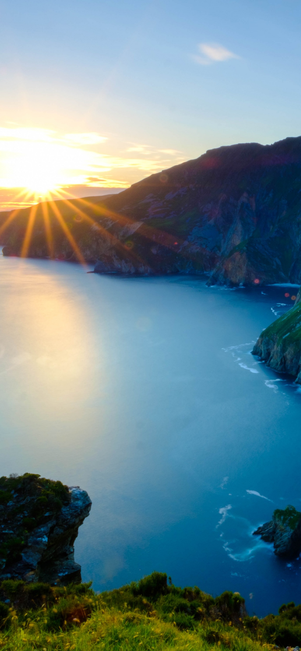 Green and Brown Mountain Beside Body of Water During Daytime. Wallpaper in 1242x2688 Resolution