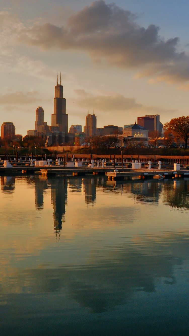 City Skyline Across Body of Water During Night Time. Wallpaper in 750x1334 Resolution