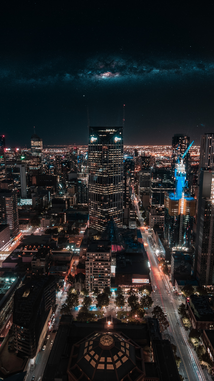 Vue Aérienne Des Bâtiments de la Ville Pendant la Nuit. Wallpaper in 750x1334 Resolution