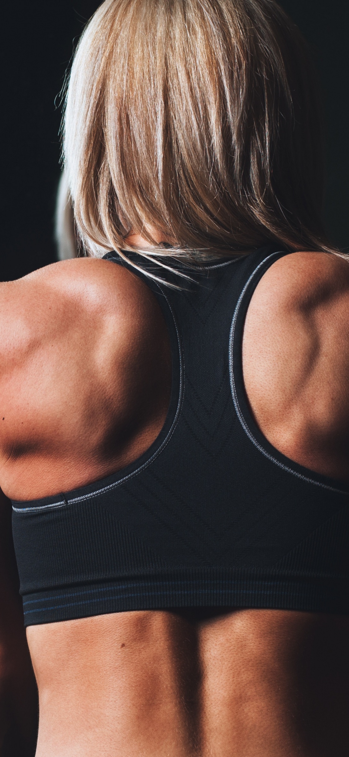 Woman in Black Sports Bra. Wallpaper in 1125x2436 Resolution