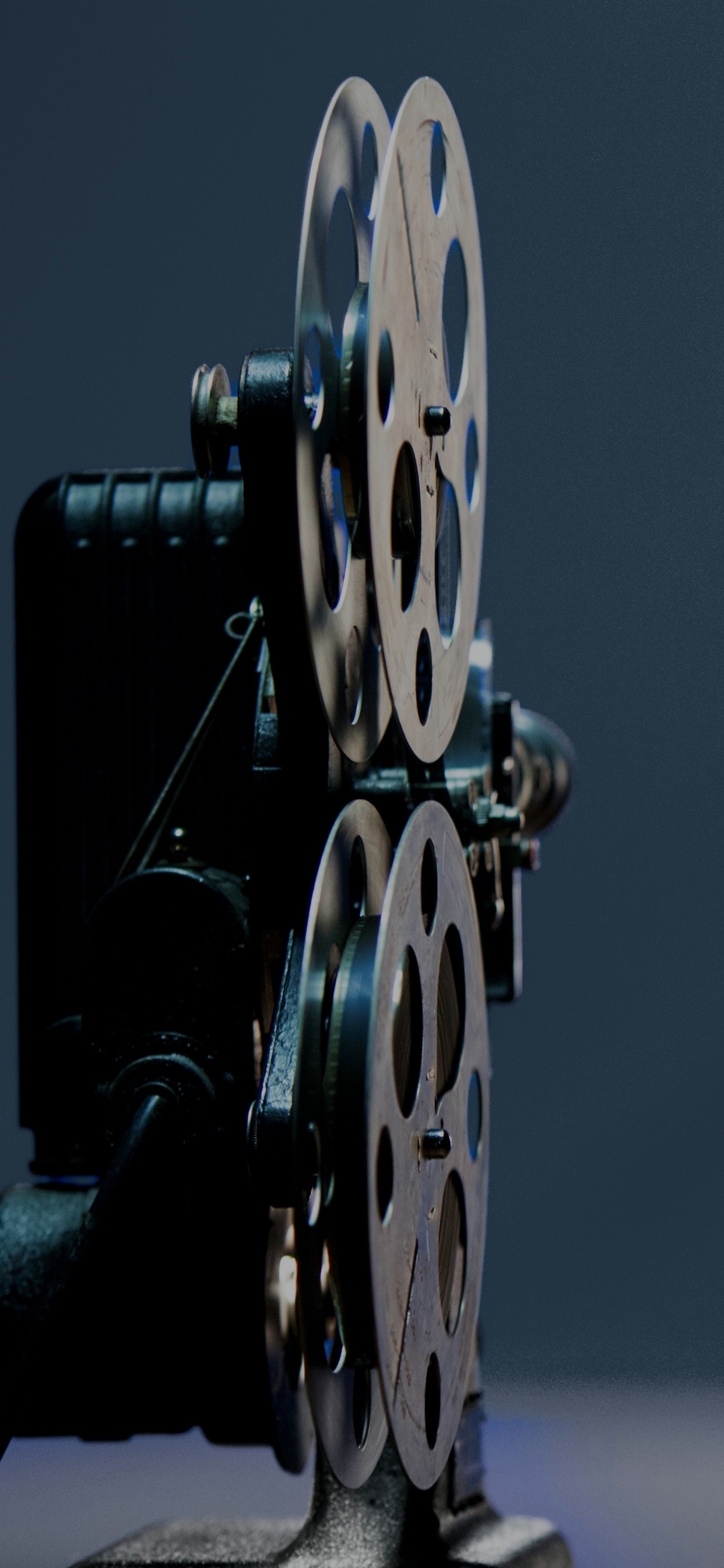Man in Black Jacket Standing Beside Blue and Yellow Round Wall Decor. Wallpaper in 1242x2688 Resolution