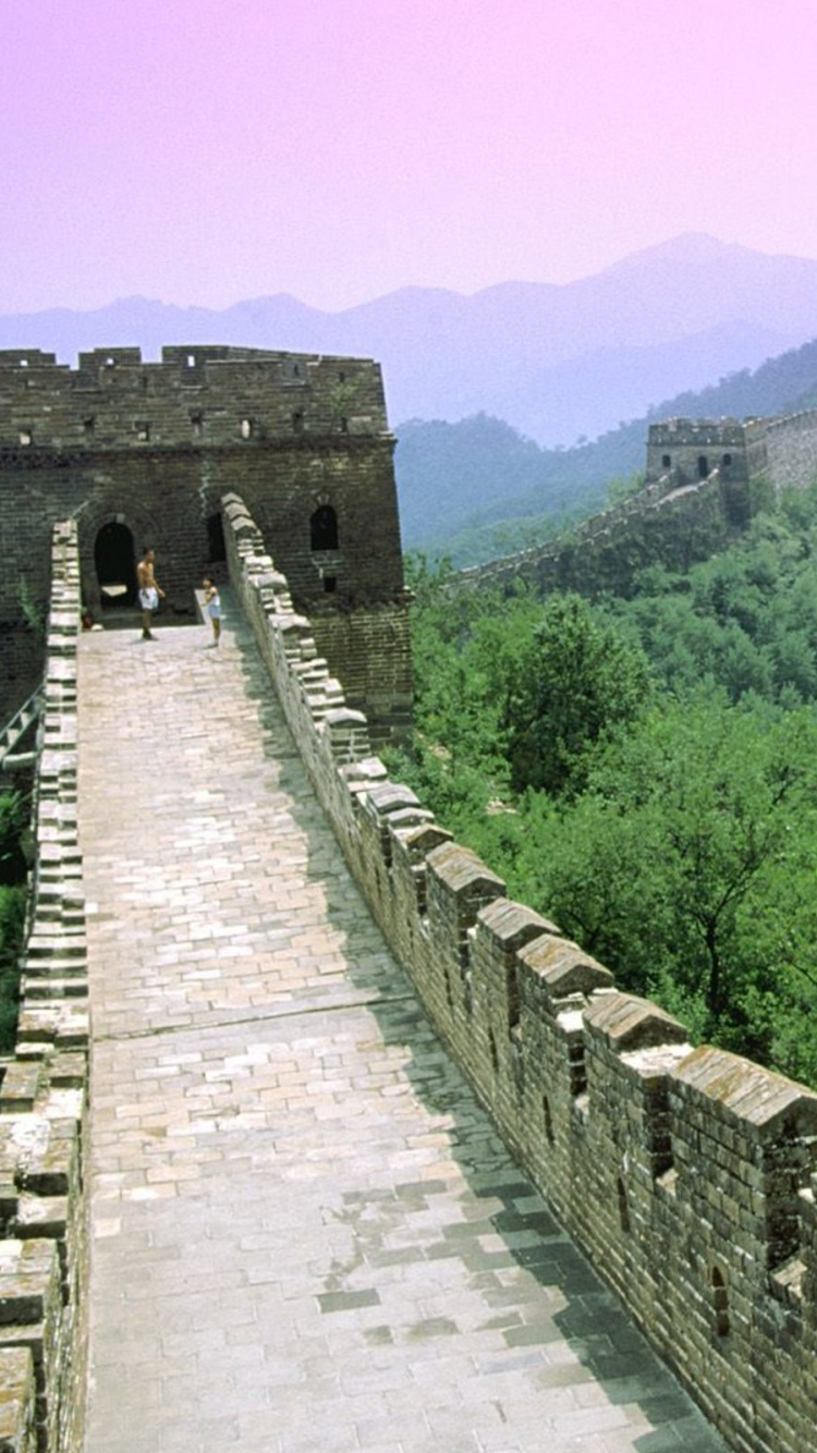 Brown Brick Wall Near Green Trees During Daytime. Wallpaper in 750x1334 Resolution
