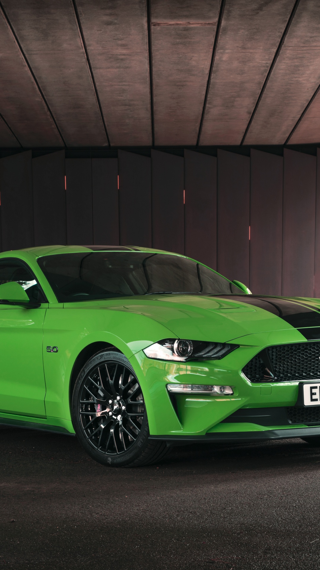 Green Porsche 911 Parked Beside Brown Brick Wall. Wallpaper in 1080x1920 Resolution