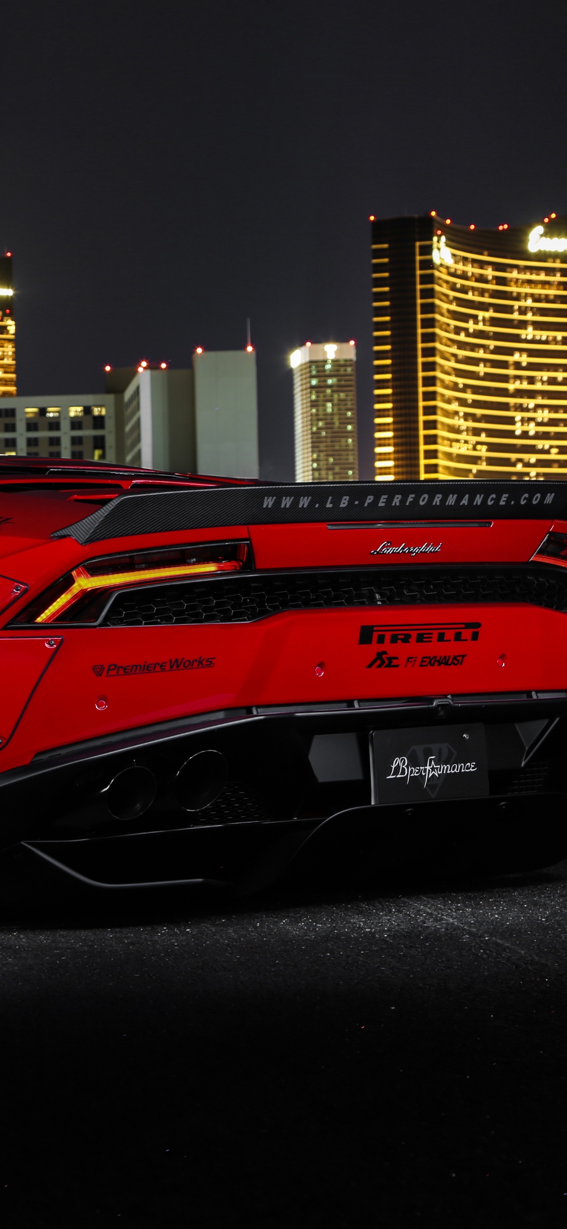 Red Ferrari 458 Italia Parked Near Building During Night Time. Wallpaper in 1125x2436 Resolution