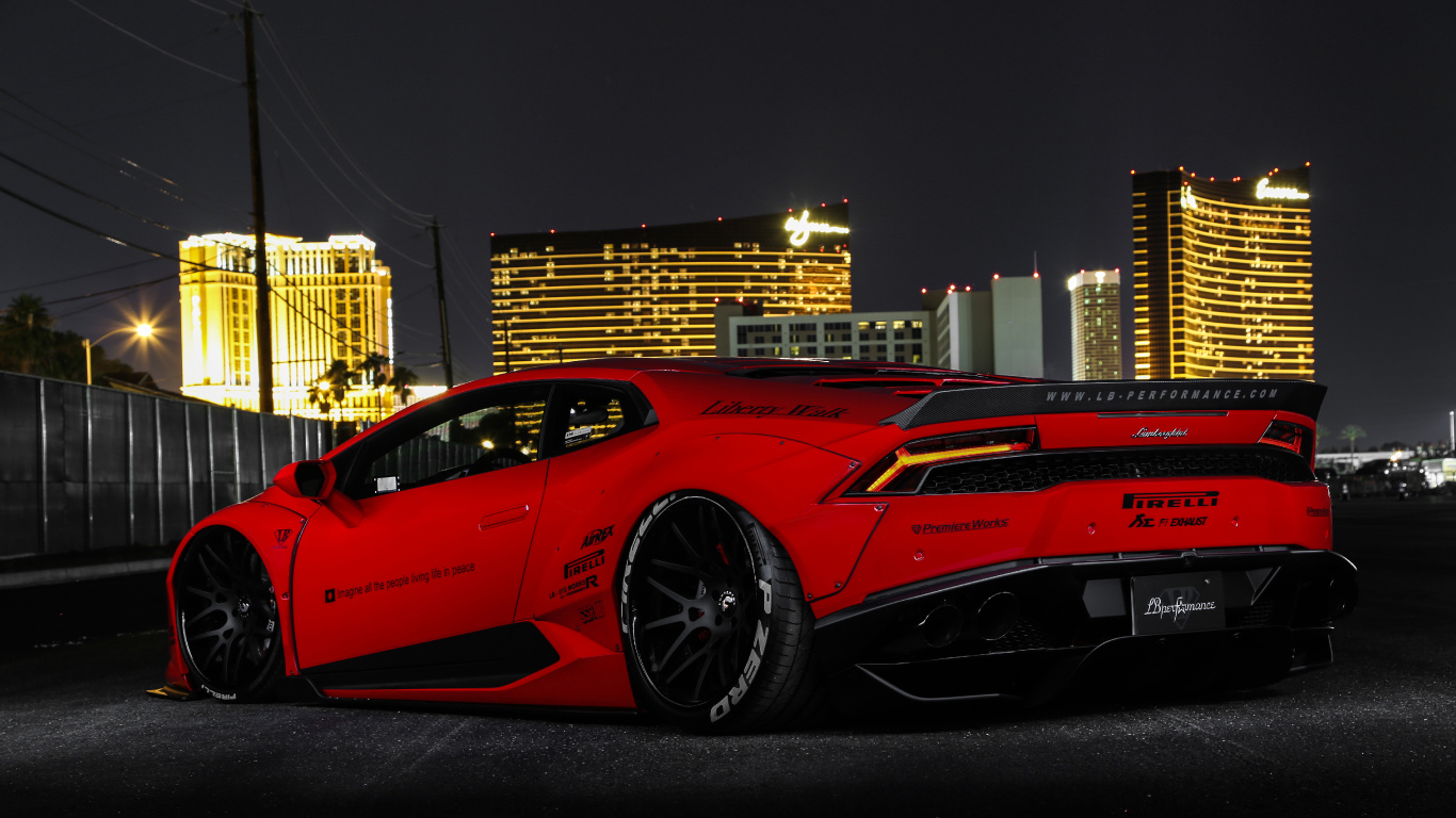 Red Ferrari 458 Italia Parked Near Building During Night Time. Wallpaper in 1366x768 Resolution