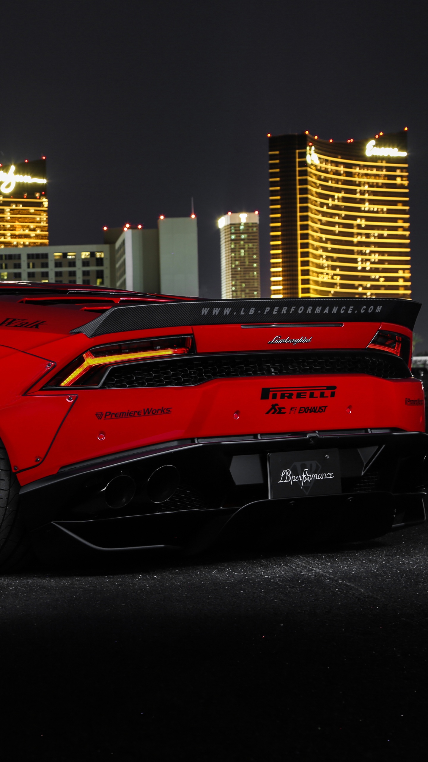 Red Ferrari 458 Italia Parked Near Building During Night Time. Wallpaper in 1440x2560 Resolution