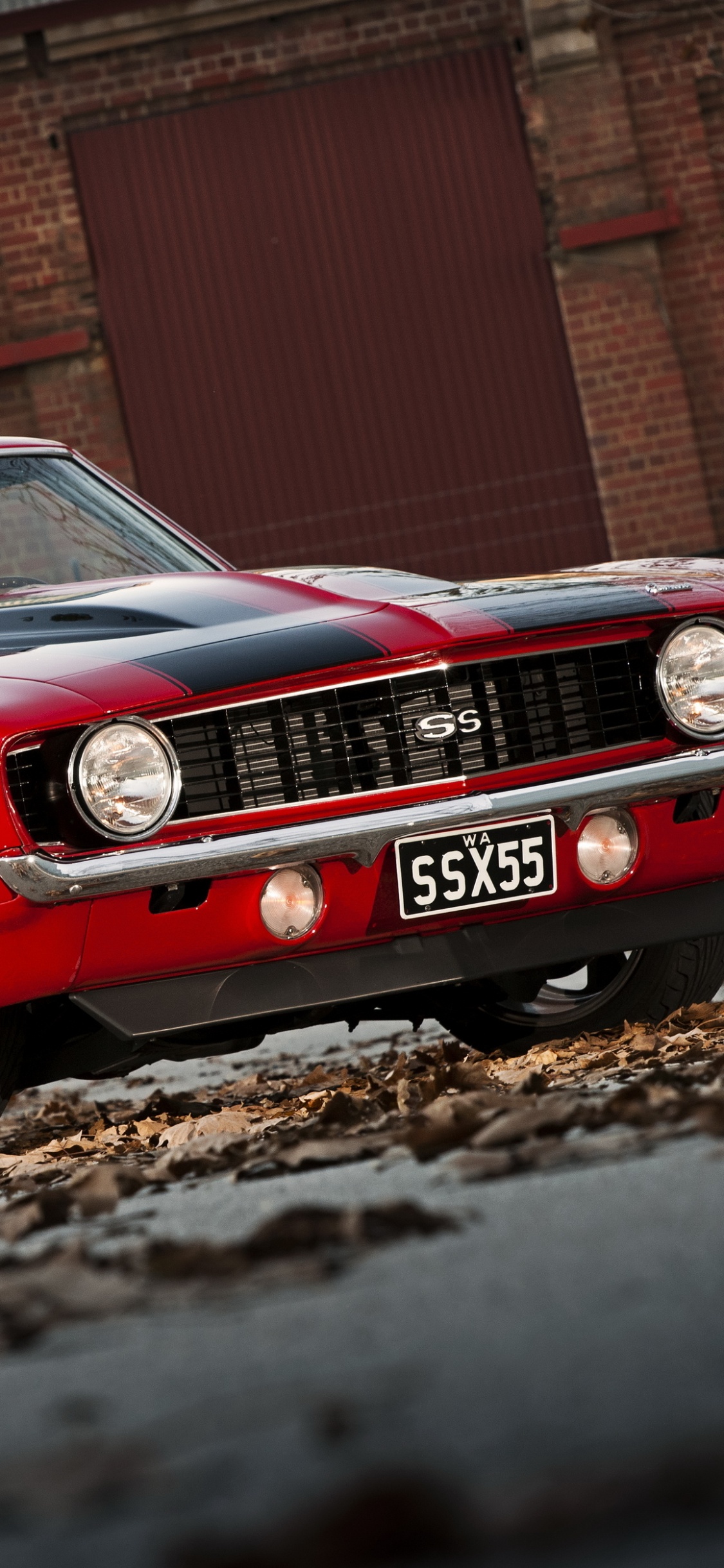 Red Mercedes Benz Coupe on Brown Soil. Wallpaper in 1125x2436 Resolution