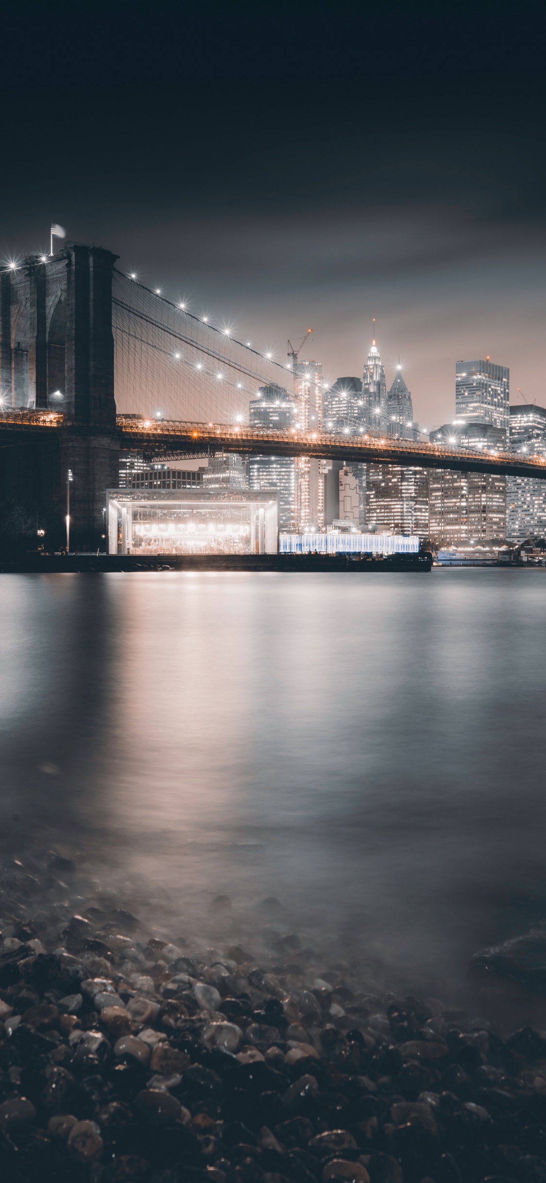 Bridge Over Water During Night Time. Wallpaper in 1125x2436 Resolution