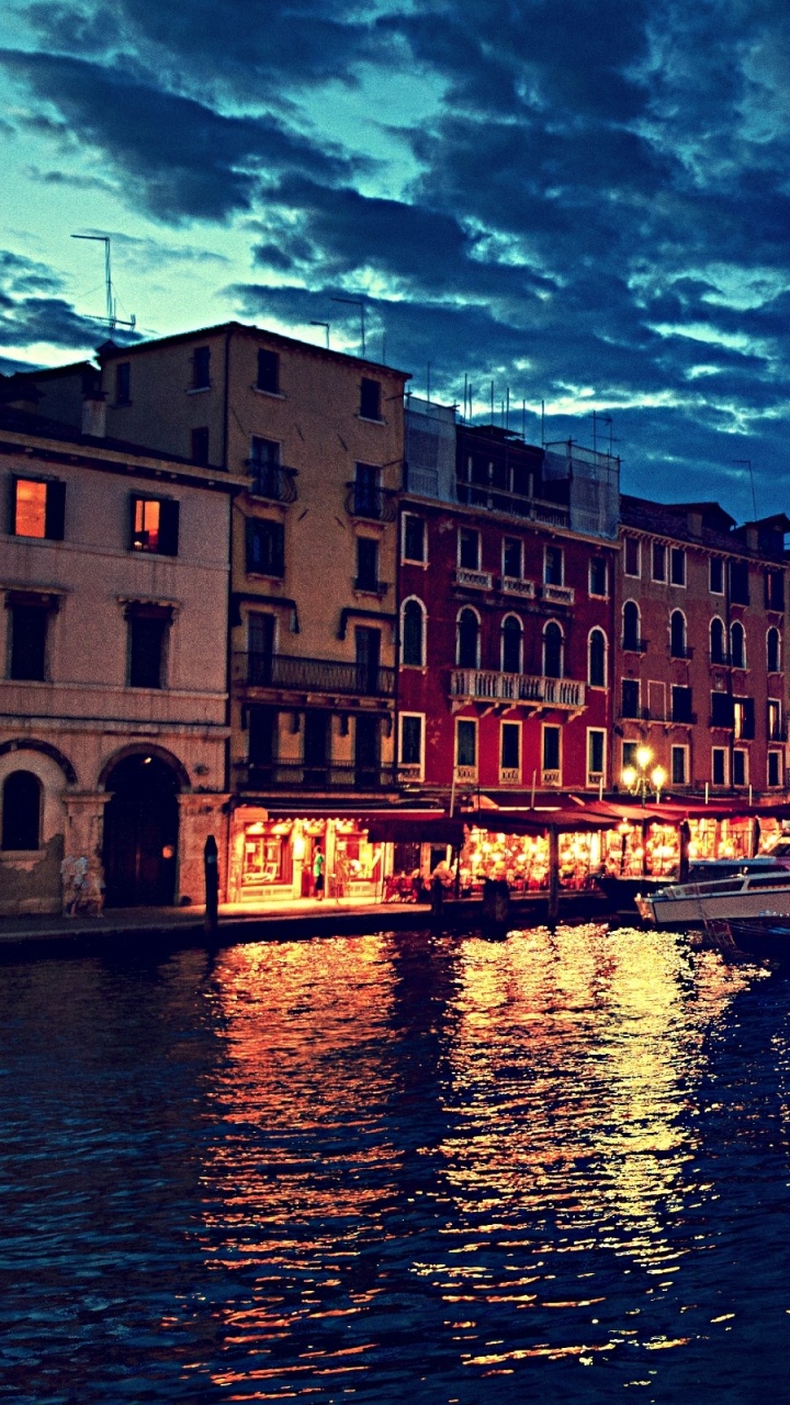 Brown Concrete Building Beside River During Night Time. Wallpaper in 720x1280 Resolution