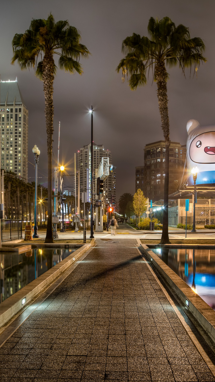 Stadtgebäude Mit Nachts Eingeschaltetem Licht. Wallpaper in 750x1334 Resolution