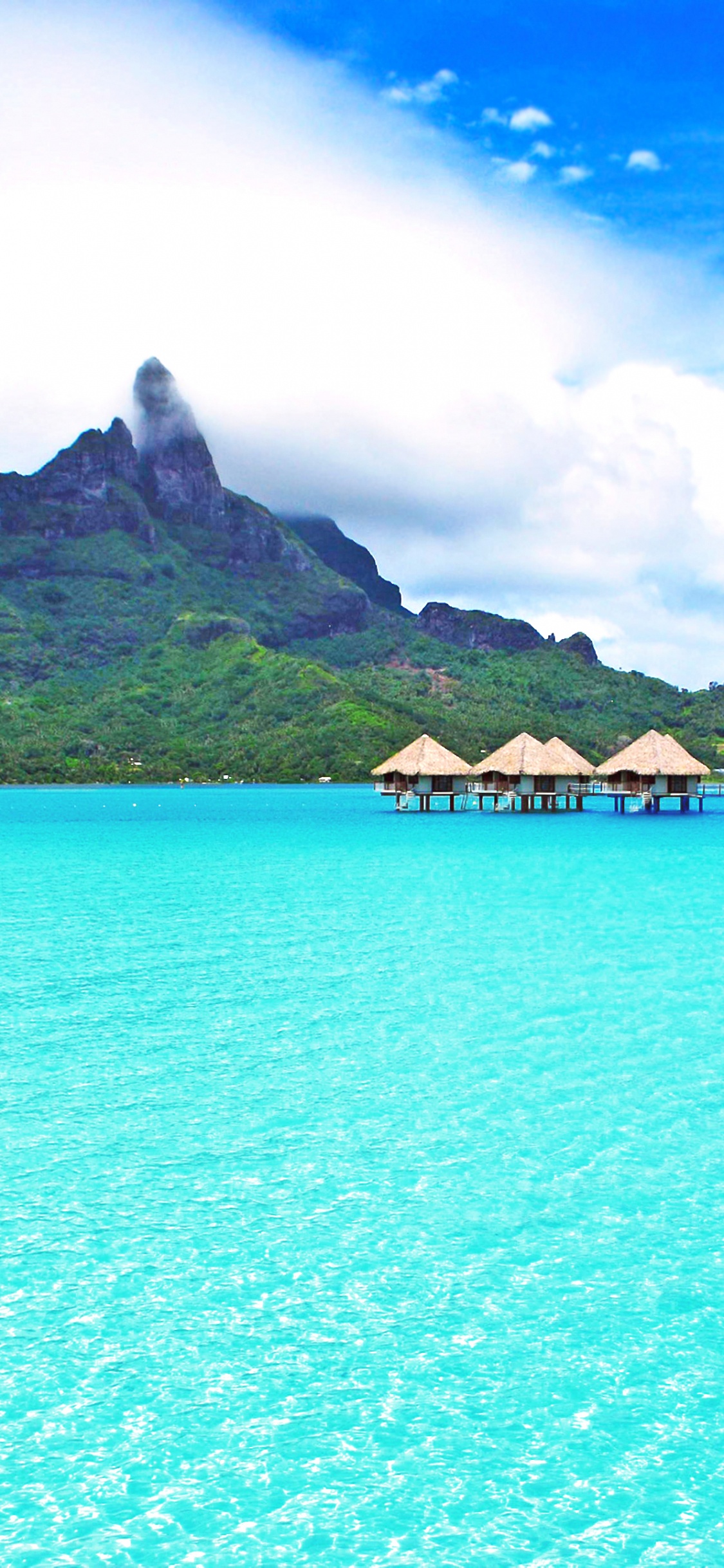 Brown Wooden House on Blue Sea Water Under Blue Sky During Daytime. Wallpaper in 1125x2436 Resolution