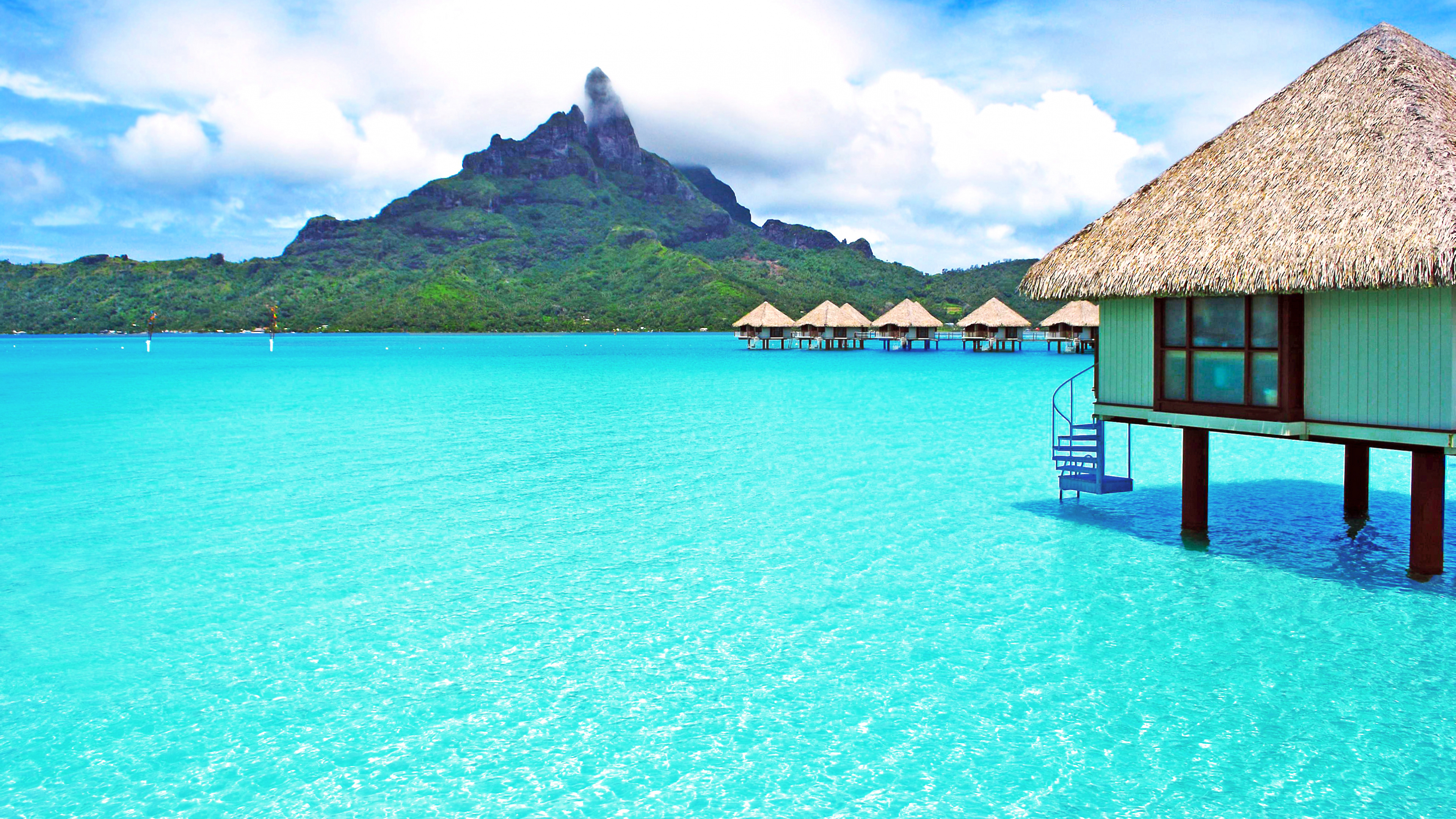 Brown Wooden House on Blue Sea Water Under Blue Sky During Daytime. Wallpaper in 3840x2160 Resolution