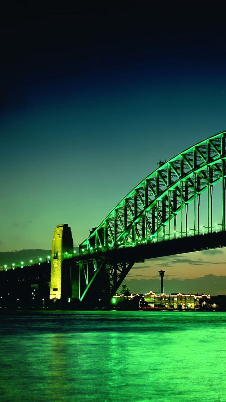 White and Black Bridge Over Body of Water During Night Time. Wallpaper in 750x1334 Resolution