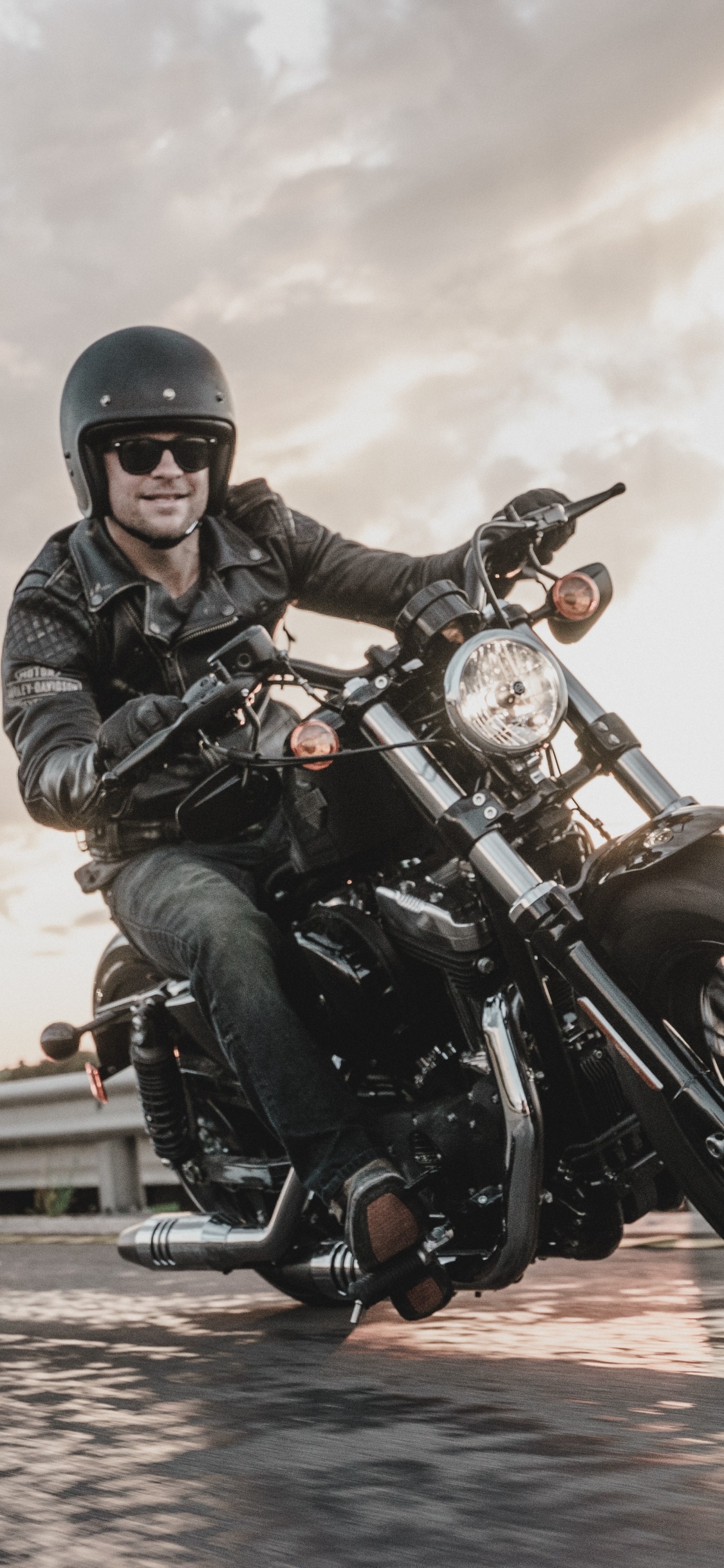 Hombre Con Chaqueta de Cuero Negro Montando Motocicleta. Wallpaper in 1125x2436 Resolution
