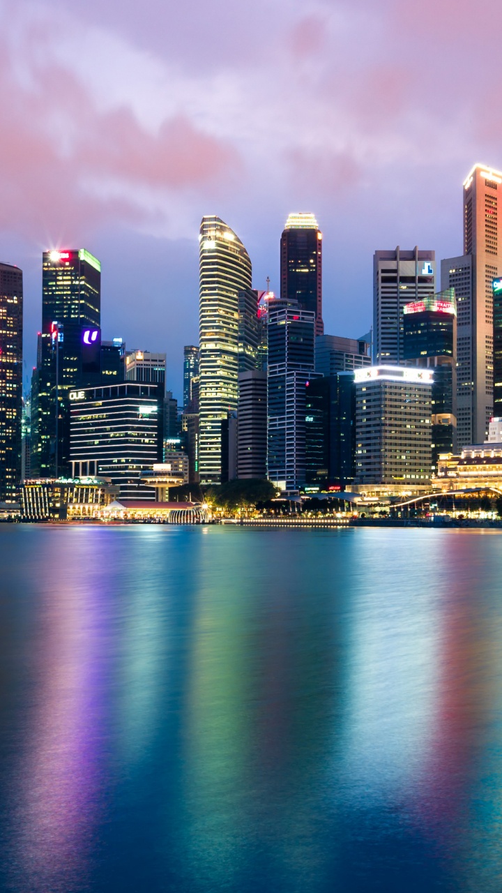 City Skyline Across Body of Water During Night Time. Wallpaper in 720x1280 Resolution