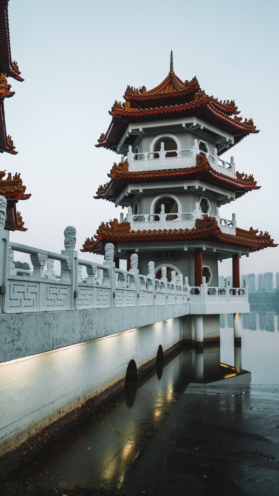 White and Red Concrete Building Near Body of Water During Daytime. Wallpaper in 1080x1920 Resolution