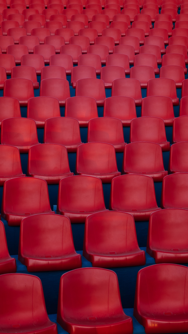 Red Plastic Chairs in Stadium. Wallpaper in 750x1334 Resolution