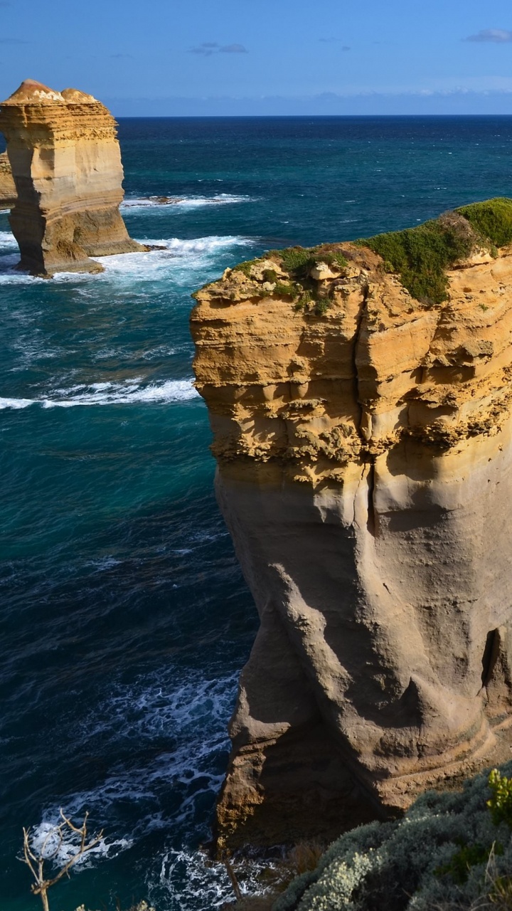 Brown Rock Formation Near Body of Water During Daytime. Wallpaper in 720x1280 Resolution