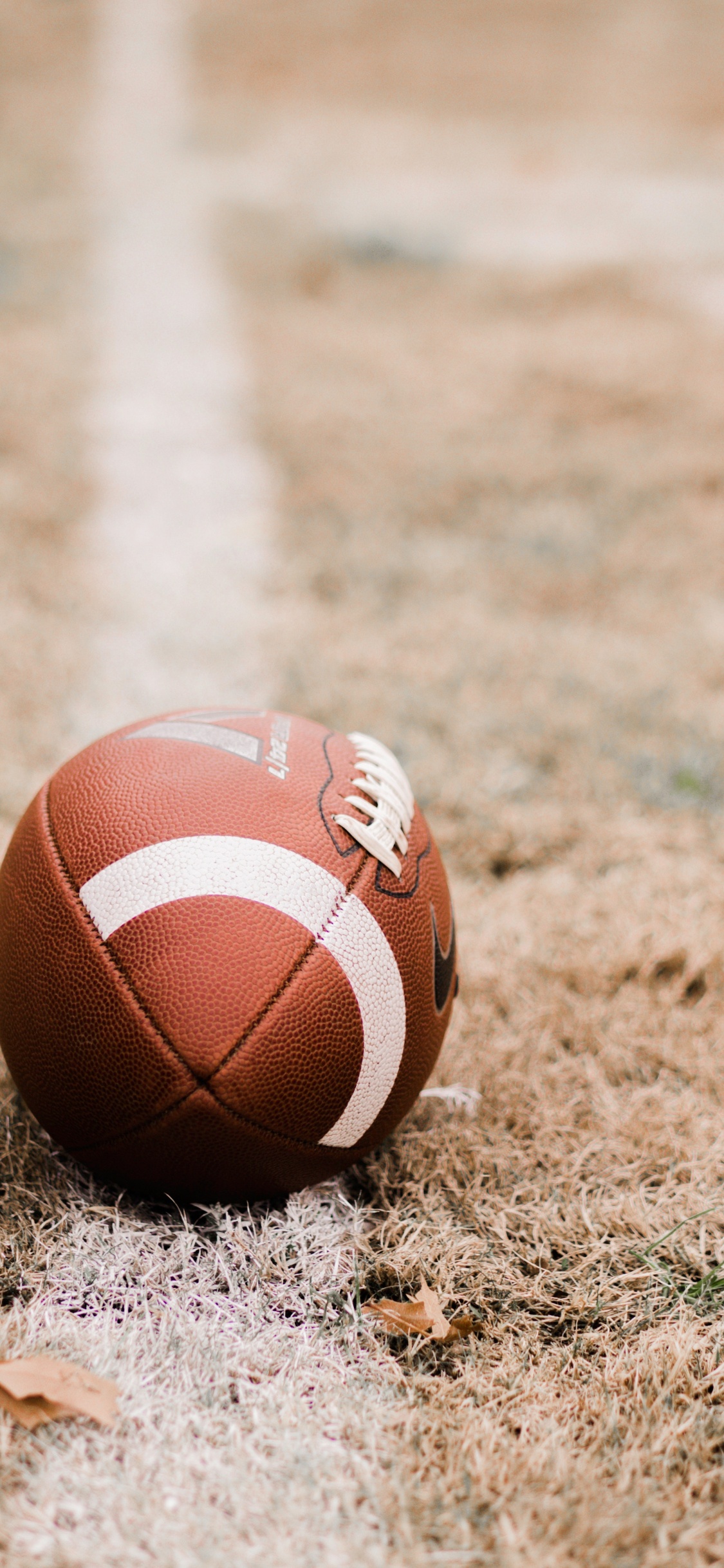 Brown Basketball on Brown Field During Daytime. Wallpaper in 1125x2436 Resolution