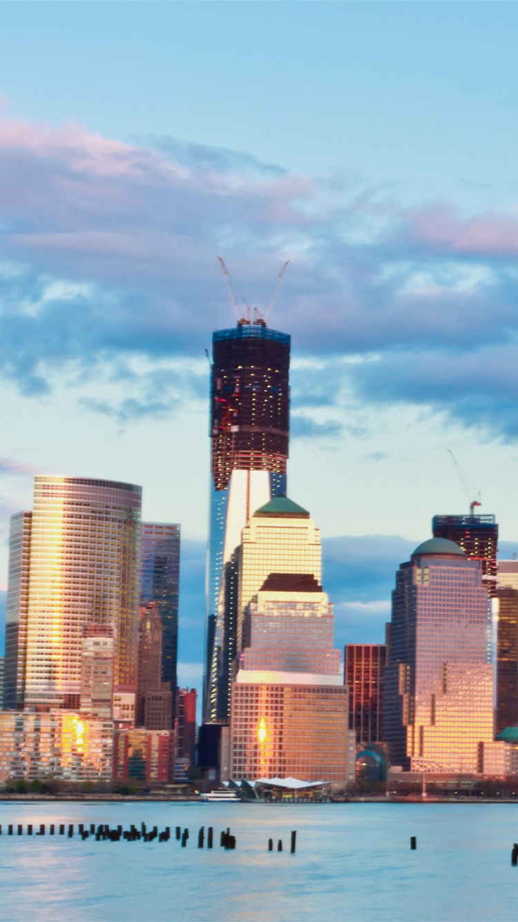 City Skyline Across Body of Water During Daytime. Wallpaper in 750x1334 Resolution
