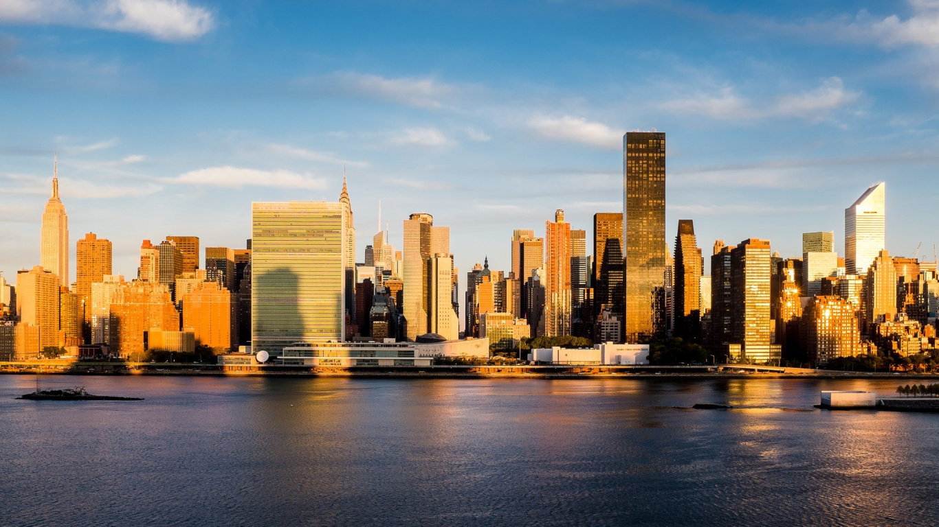 City Skyline Across Body of Water During Daytime. Wallpaper in 1366x768 Resolution