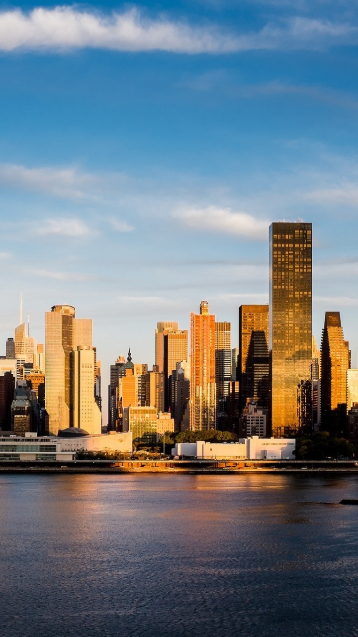 City Skyline Across Body of Water During Daytime. Wallpaper in 720x1280 Resolution
