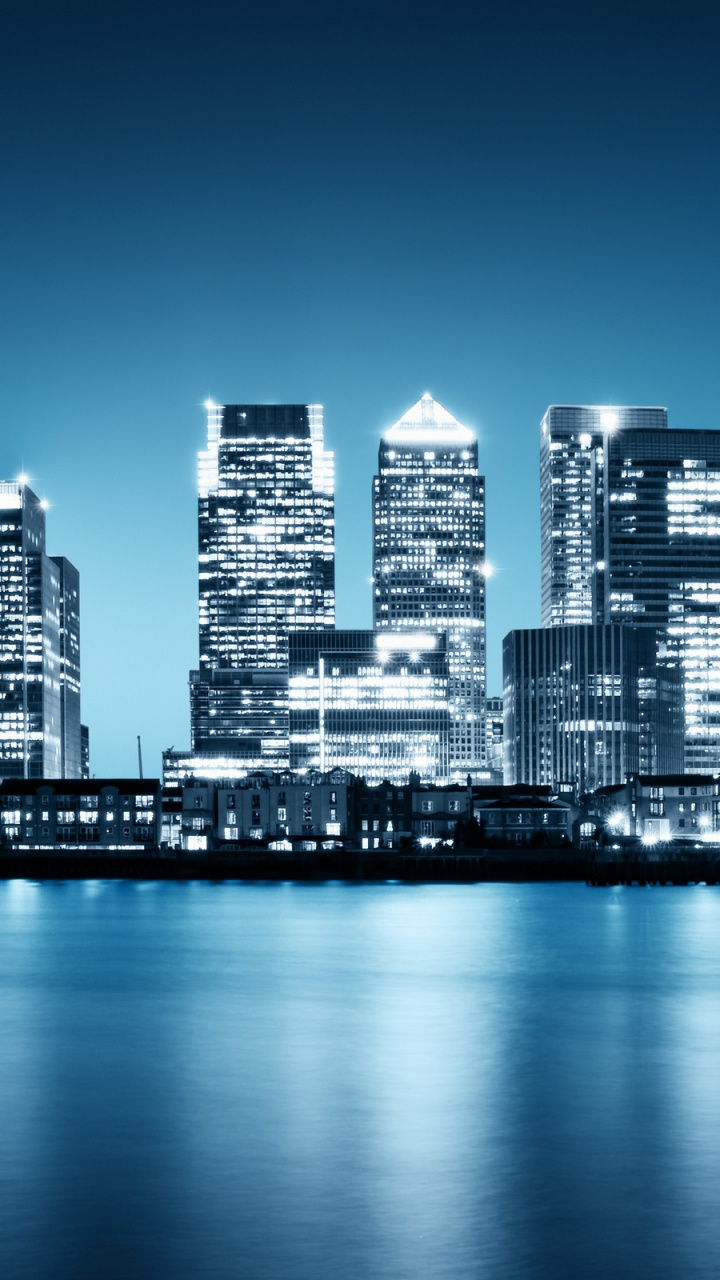 City Skyline Across Body of Water During Night Time. Wallpaper in 720x1280 Resolution