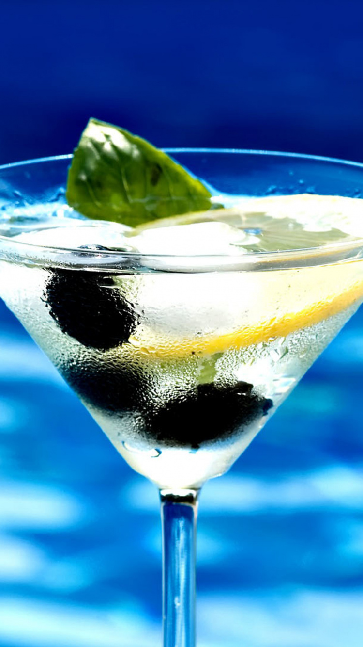 Clear Cocktail Glass With Sliced Lemon and Black Liquid. Wallpaper in 750x1334 Resolution