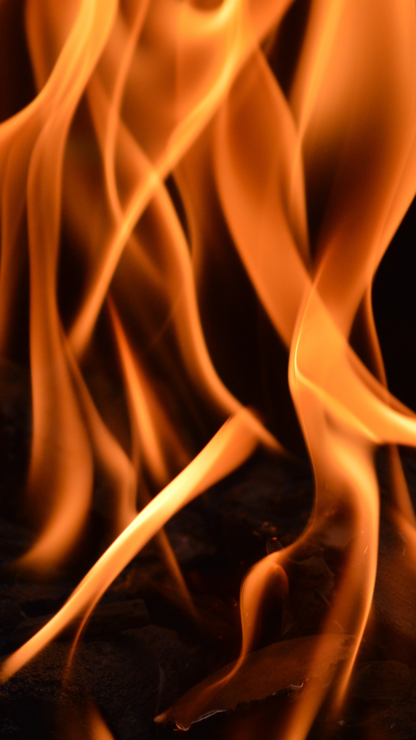 Orange Fire in Black Background. Wallpaper in 1440x2560 Resolution