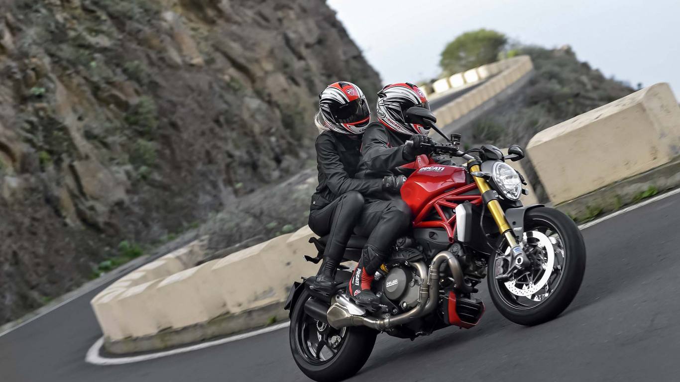 Man in Black and Red Motorcycle Suit Riding Motorcycle on Road During Daytime. Wallpaper in 1366x768 Resolution