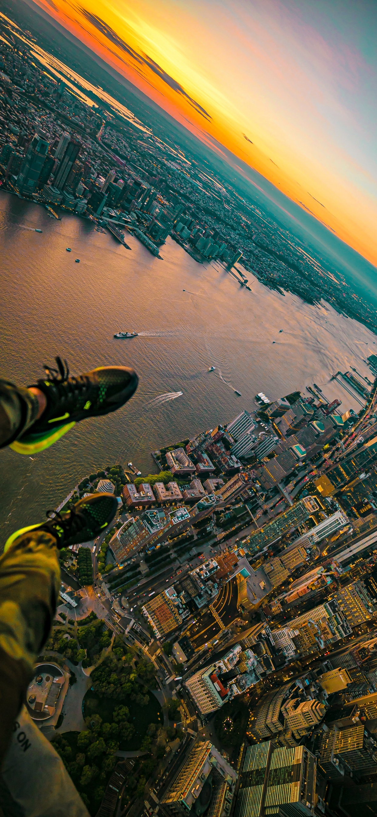 Aerial View of City Buildings Near Body of Water During Daytime. Wallpaper in 1242x2688 Resolution