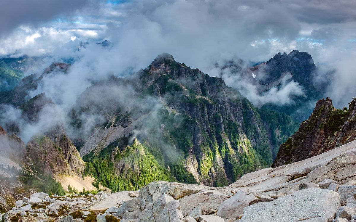 green and brown mountain under white clouds during daytime