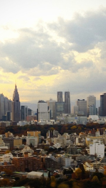 Image city buildings under white clouds during daytime