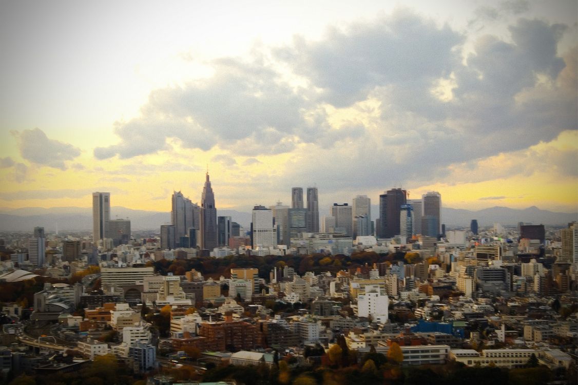 city buildings under white clouds during daytime