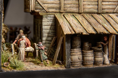 Image children sitting on wooden bench in front of wooden house during daytime
