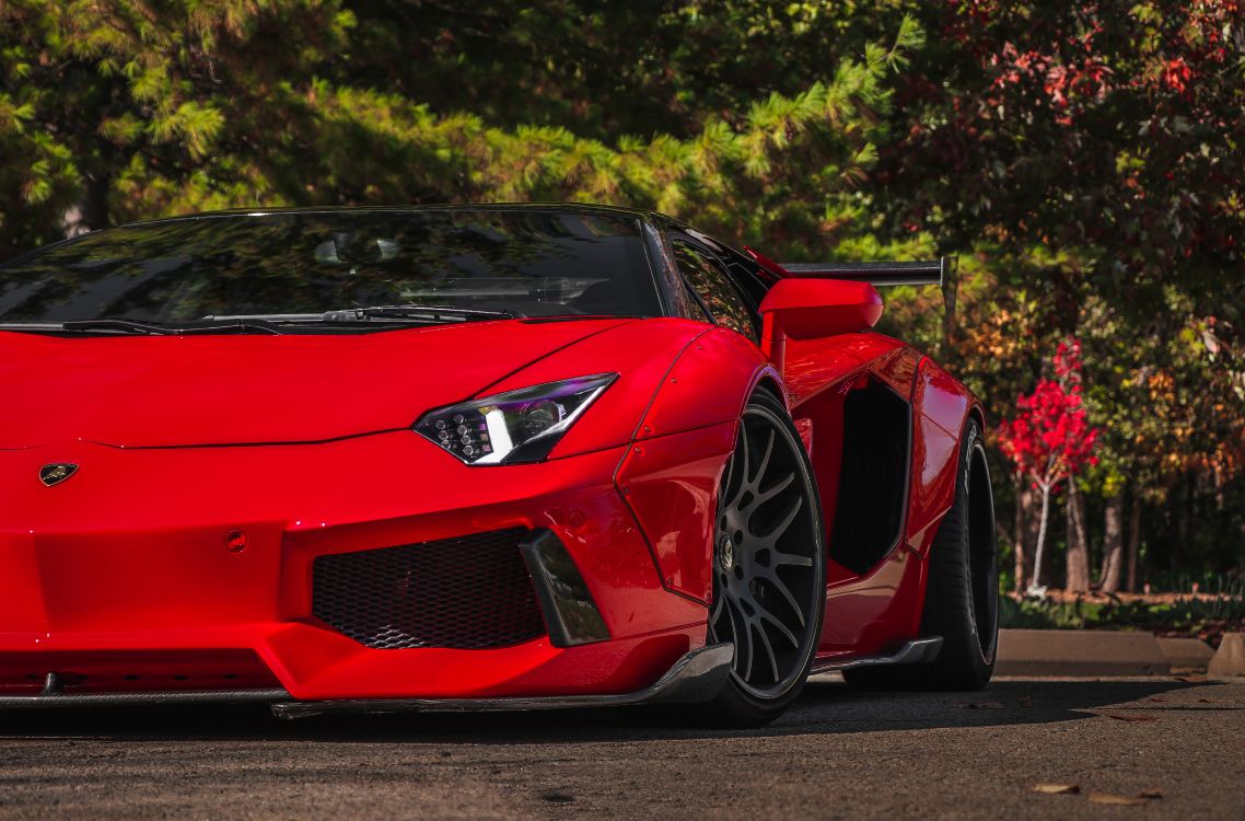 red ferrari 458 italia on road during daytime