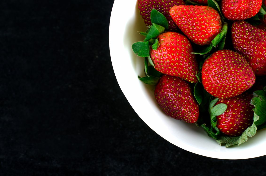 strawberries on white ceramic bowl