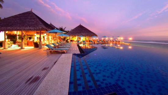 Image brown wooden house near body of water during night time