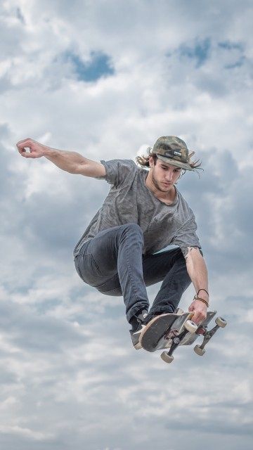 Image man in gray t-shirt and black pants wearing black helmet