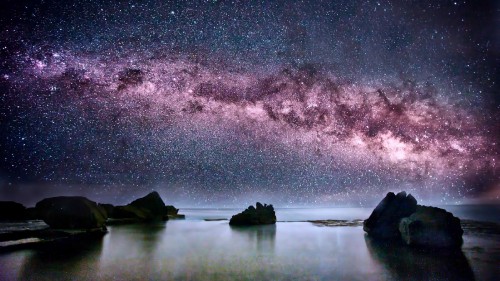 Image body of water near mountain during night time