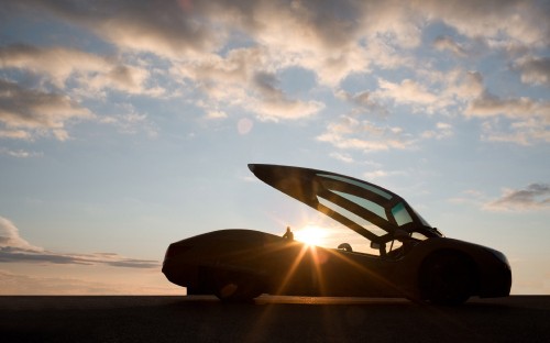 Image black ferrari 458 italia on beach shore during daytime