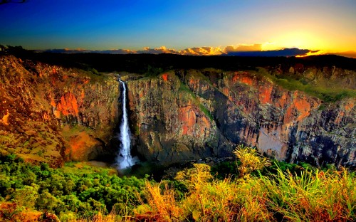 Image waterfalls on brown rocky mountain under blue sky during daytime
