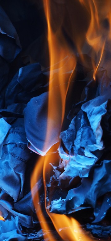 Image blue and orange flame on black surface