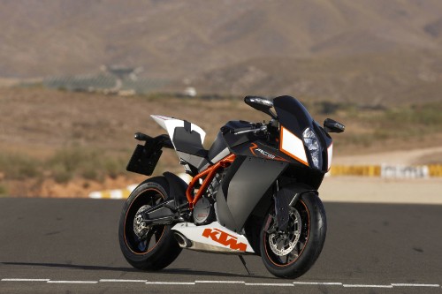 Image black and orange sports bike on road during daytime