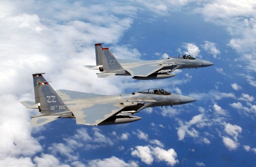 Image two fighter planes flying in the sky during daytime