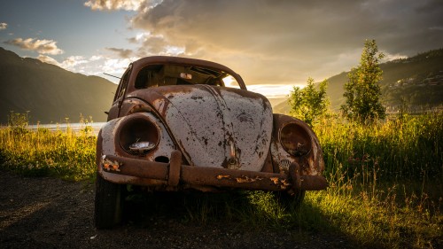 Image brown vintage car on green grass field during daytime