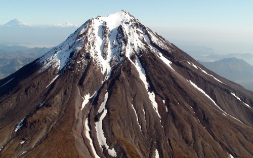 Image brown and white mountain under blue sky during daytime