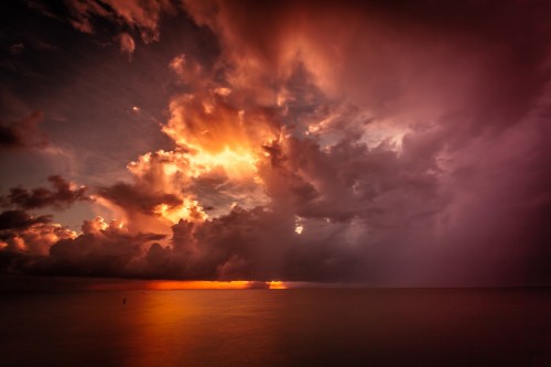 Image body of water under cloudy sky during sunset