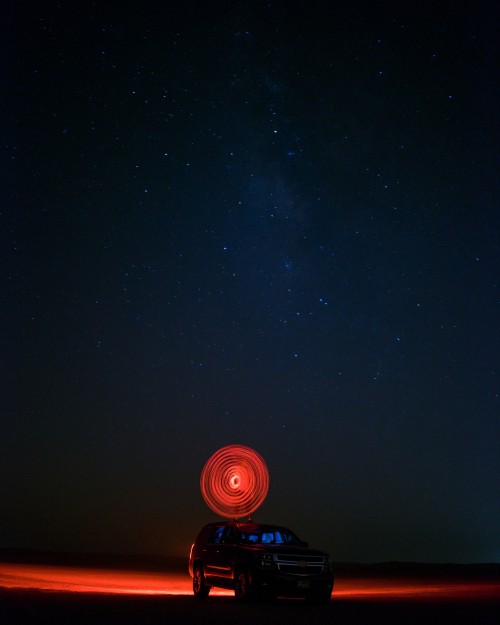 Image black and red lighted dome tent under starry night