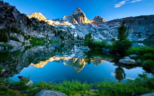 Image snow covered mountain near lake during daytime